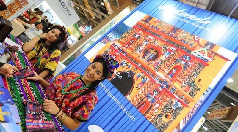 Turismo en Guatemala, una mujer vestida de indigena en un puesto en Francia